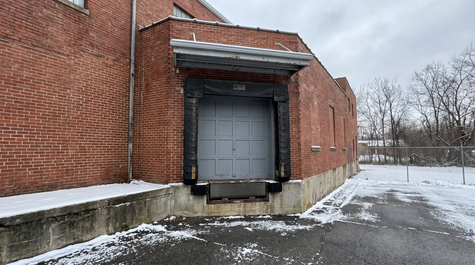 Loading dock door with a black dock seal around the opening